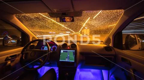 The man drive vehicle in the rainy city. Evening night time Stock Photos