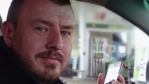 Man driver in the car talks by mobile phone Stock Footage 74713585