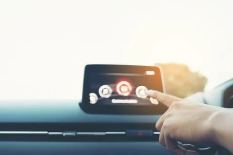 Man Driver entering an address into the navigation system, male hand pointing Stock Photos