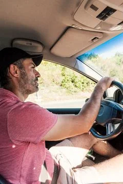 Man driver hold steering wheel car drive along highway, summer travel vacatio Stock Photos