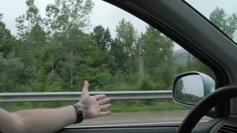Man driver put his hand out the car window. Road trip, car travel concept Video stock 205023279