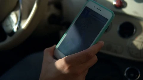 Man driver using smart phone car mobile driving steer steering wheel holding Stock Footage 119289487