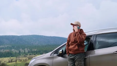 Man driver using smartphone calling auto service assistance. Road trip trouble. Stock Footage 240987110