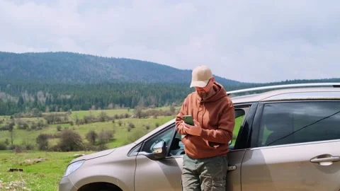 Man driver using smartphone calling auto service assistance. Road trip trouble. Видео 243618232