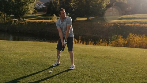 Man drives ball as camera circles during sunset Video stock 102672618