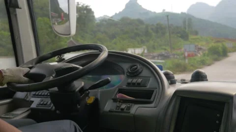 A man drives a bus on the rough road to Yangshuo, China Stock Footage 231738702