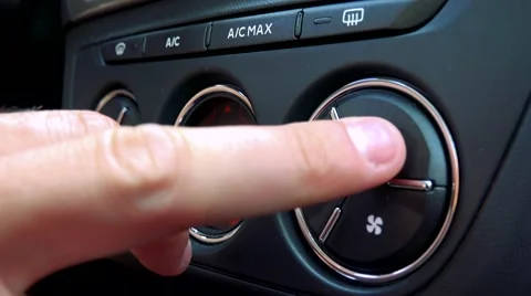 Man drives a car and control air-conditioning in the car - detail Stock Footage