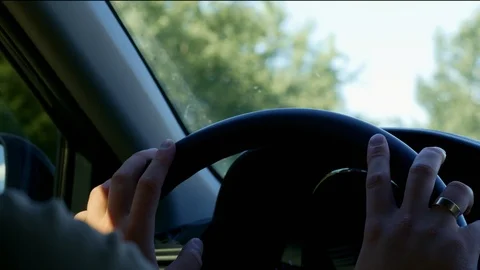 A man drives a car, close-up of hands on the steering wheel Stock Footage 113734904