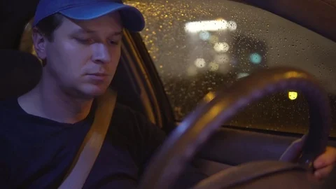A man drives a car in the evening. Stock Footage 81627648