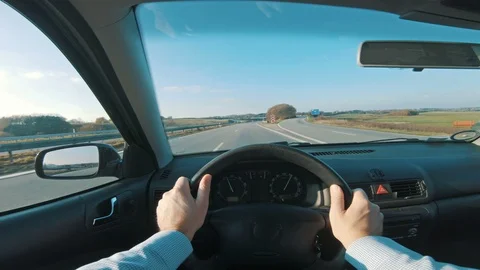 Man drives car fast on freeway and holds on to the steering wheel Stock Footage 98662640