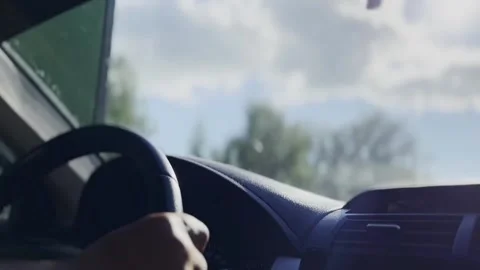 A man drives a car with his hands on the steering wheel. Road trip. Vidéo 202604342