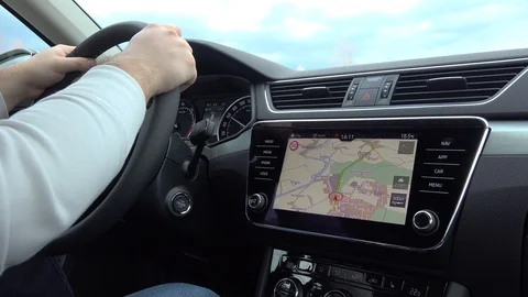 A man drives a car, using his car navigation system to see the map. A view of Stock Footage 123636289