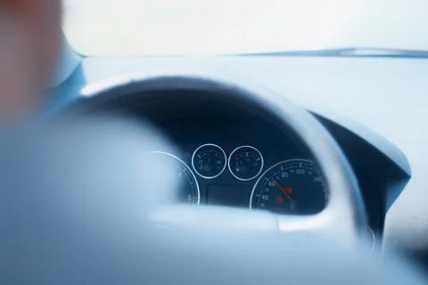 A man drives a car. View inside the cabin on the dashboard. Stock Photos