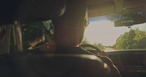 Man drives the car while sunset.  Young man driving the car.  Young adult boy Stock Footage 131042033