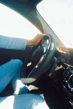 Man drives car while wearing a blue suit and holding the steering wheel with  Stock Photos
