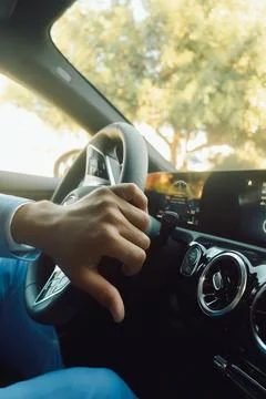 Man drives car while wearing a blue suit and holding the steering wheel with  Stock Photos