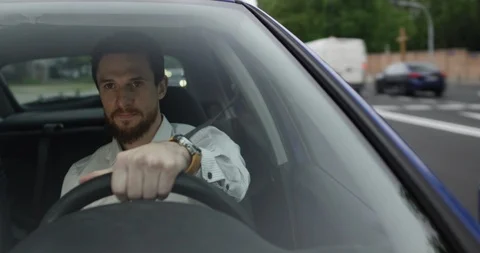 Man drives car to work in heavy traffic view through front window Stock Footage 110048038