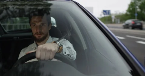 Man drives car to work view through front window Stock Footage 110047844
