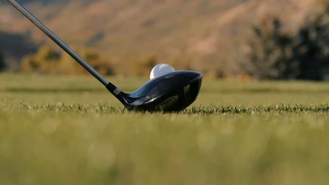 Man drives golf ball on tee close up with grass flying Stock-Footage 102672609