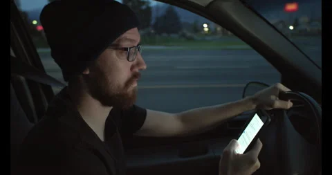 Man drives in morning while texting 스톡 동영상 245400434
