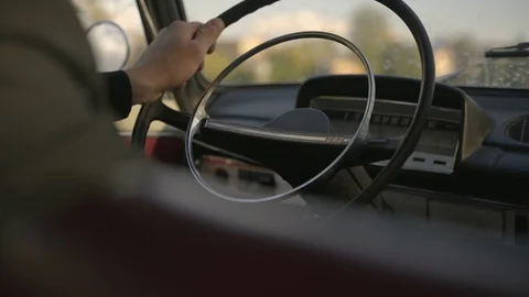 Man drives old soviet car and holds steering wheel Video stock 127850174
