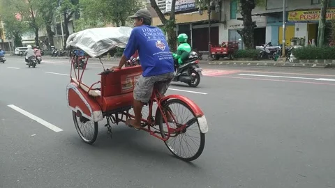 A man drives a rickshaw on the streets Stock Footage 270074884