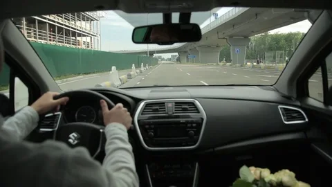 A man drives Suzuki, turn the steering wheel of a vehicle Stock Footage 78697341