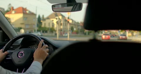 A man drives through a bustling city, showcasing vibrant urban life Stock-Footage 314347161