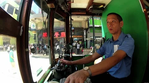 Man drives the vintage double-deck tram in Hong Kong, China. Stock Footage 58452348