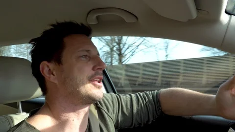 A man driving angry and shouting at the other driver on a highway Stock Footage 104304227