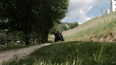 Man driving an ATV on an old way - runs over the camera -with sound Video stock 168411329