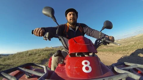 A man driving a ATV in a open field dirt road in Mexico Stock Footage 113301434