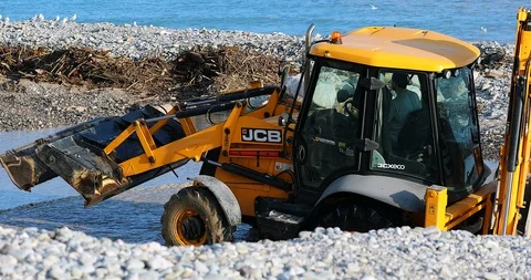 Man Driving Backhoe Loader In River Water Stock Footage 122337355