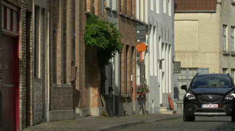 Man driving a black car on Goezeputstraat in Bruges Stock Footage 59673840