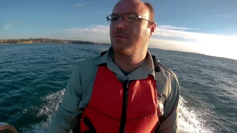 Man driving boat Stock Footage 74290278