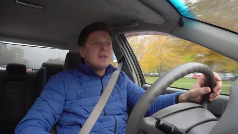 A man is driving a car and is singing. Stock Footage 81232178
