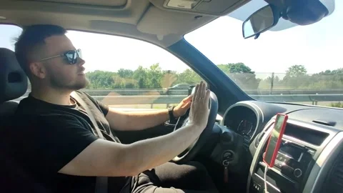 Man driving car and singing Stock Footage 166409765