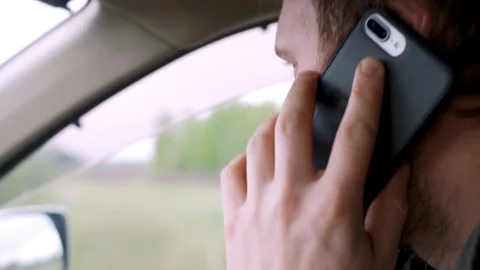 Man driving car and talking on mobile phone Stock-Footage 111133901