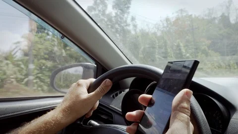 Man Driving Car and Trying to Find Direction with Navigator on Mobile Phone Stock Footage 102497383