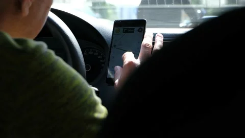 A man driving a car and using navigator Stock-Footage 130828658
