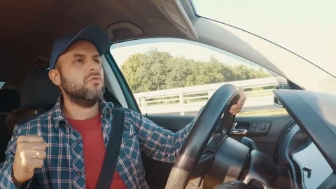 Man driving car, dancing and listening to music. Man singing and dancing happ Stock Footage