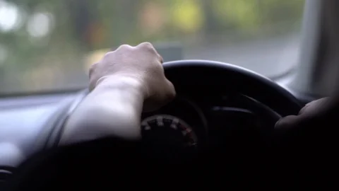 Man driving car in day time, hand on steering wheel, shallow depth of field 库存影片 126310053