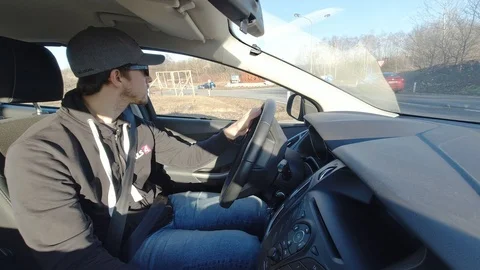 Man driving a car onto to a freeway Stock Footage 122383650