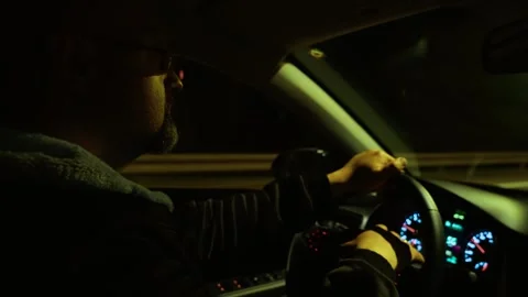 Man driving car with hands on steering wheel, dashboard displaying speed and Stock Footage 318451817