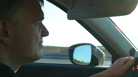 Man driving a car on a highway Stock Footage 313533047