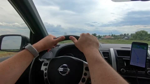 Man driving car by highway navigation on the phone Stock Footage 144342070