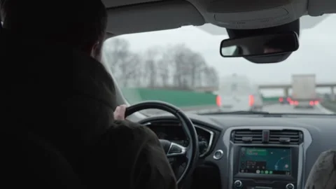 Man driving car on highway using navigation system, inside view Stock Footage 319975564