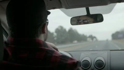 Man Driving Car on Interstate Highway While Talking Stock Footage 343935133