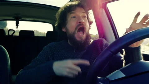 Man driving car looking camera making love sign Stock Footage 130404044