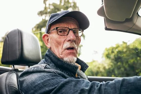 Man driving car looking at camera. Stock Photos